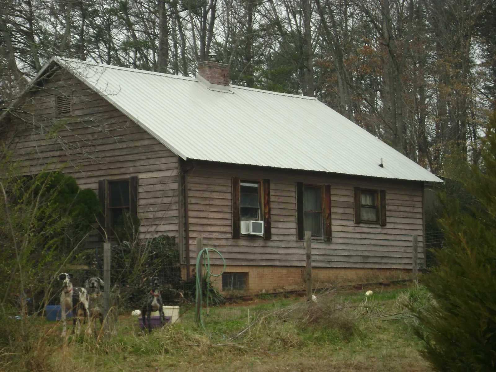 White metal roof on an old wood sided farmhouse, from a Metal Roof Installation job in Gerlach